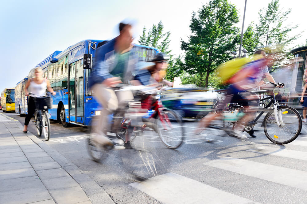 Blurred image of cyclist and bus