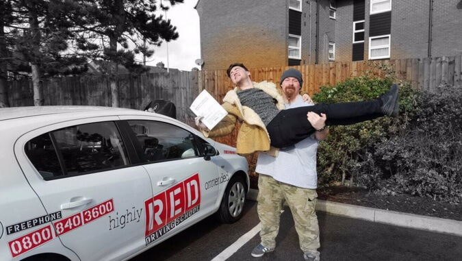 Jake Roche celebrates his first time pass with RED Driving School instructor Scott Cooper